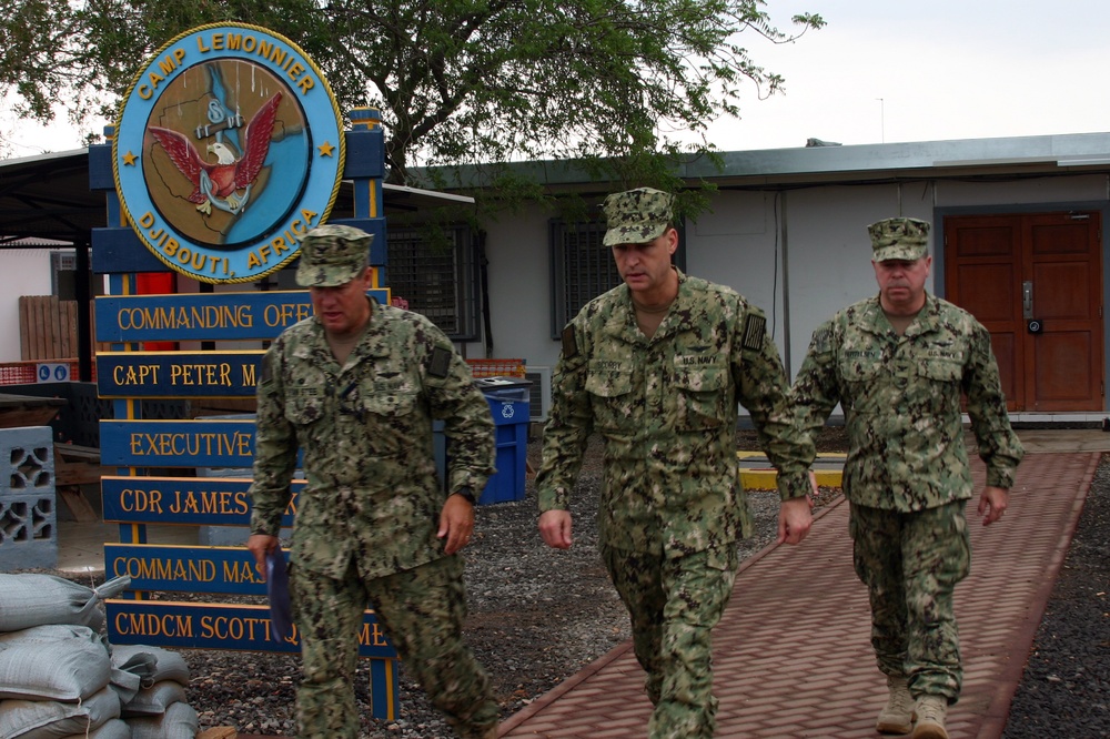 U.S. Navy personnel beside the Camp Lemonnier sign in Djibouti